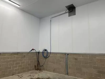 Wash boom and hose connection point installed in the pallet washing area at a logistics facility in Ellistown.